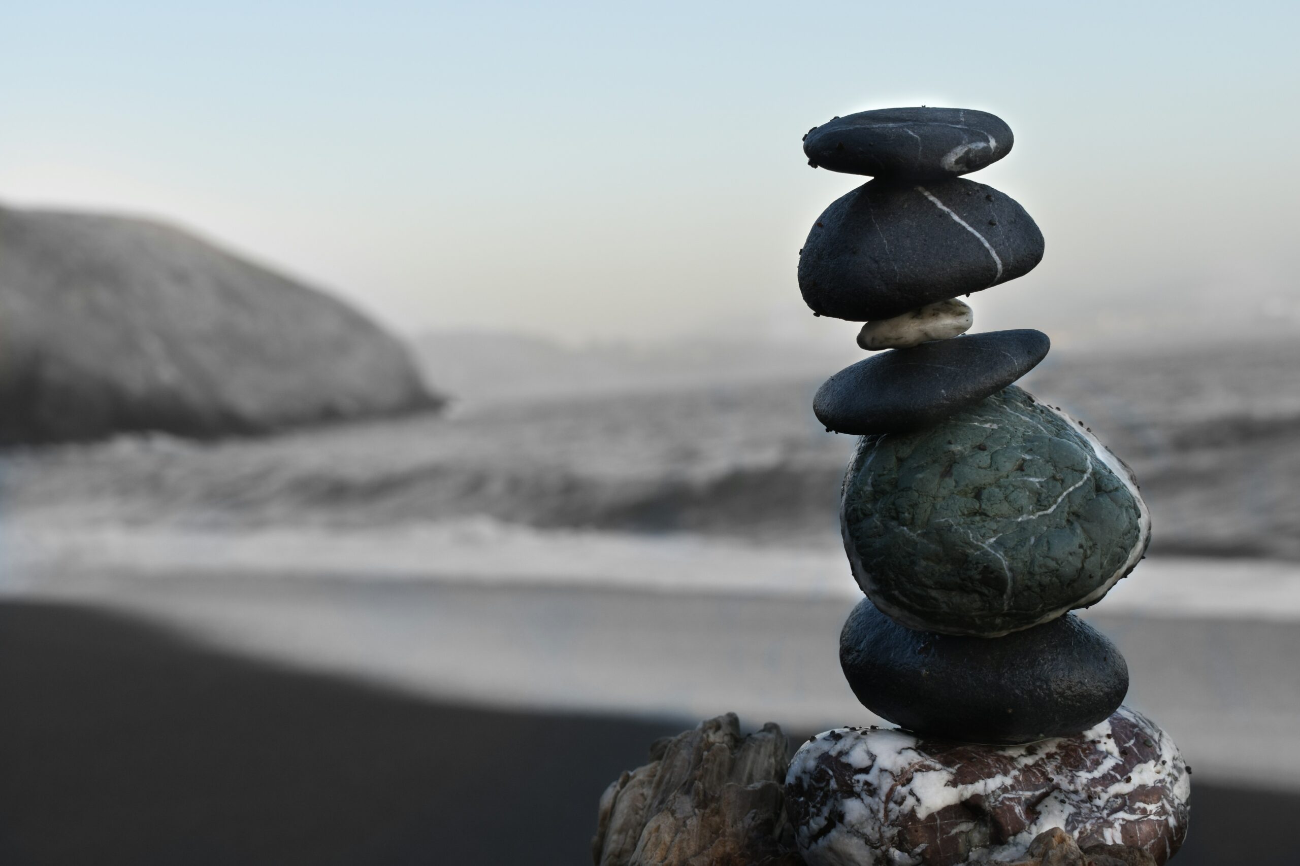Stacked stones on a beach, symbol of balance and stability, finding inner peace